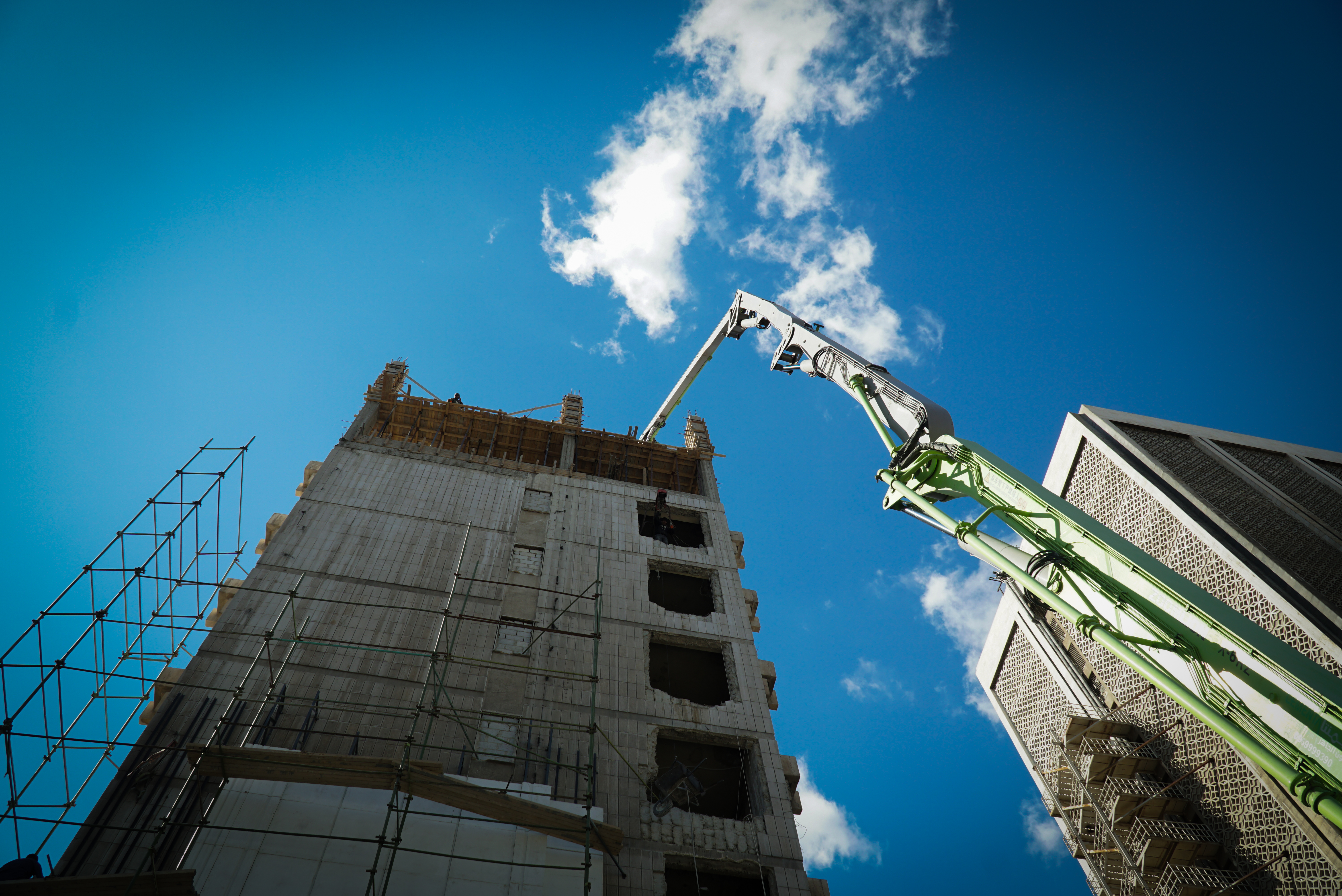 Workers handling concrete at project site